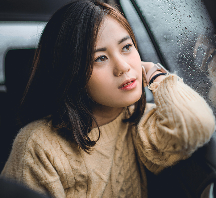 Young woman looking out a rainy car window, reflecting on a Bible-based revenge plan against a religious couple.